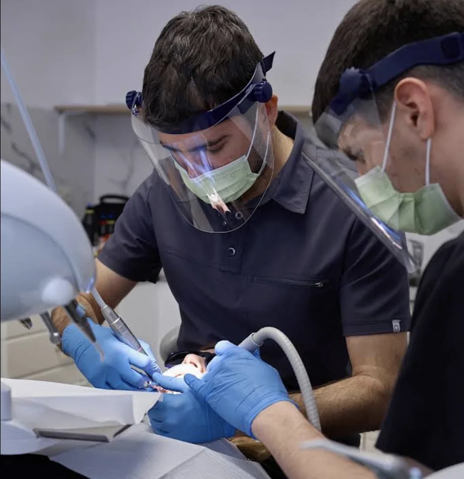 Dentist and assistant treating a tooth in a LumiDent surgery
